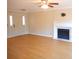 Bright living room with wood floors, ceiling fan and fireplace at 9331 Hanworth Trace Dr, Charlotte, NC 28277