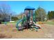 Colorful community playground with slides, climbing structures, and a soft mulch ground, ideal for fun at 9331 Hanworth Trace Dr, Charlotte, NC 28277