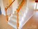 Carpeted staircase with white risers and light wood railing at 9331 Hanworth Trace Dr, Charlotte, NC 28277
