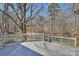 Spacious wooden back deck overlooking a serene, wooded backyard at 9505 Kent Village Dr, Charlotte, NC 28269