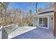 A wooden back deck adjacent to a house with a sliding glass door, offering outdoor access at 9505 Kent Village Dr, Charlotte, NC 28269