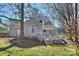 Inviting backyard with wooden deck, perfect for outdoor entertaining and relaxation under mature trees at 9505 Kent Village Dr, Charlotte, NC 28269