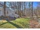 Scenic view of backyard featuring wooded surroundings, a wooden fence and a deck at 9505 Kent Village Dr, Charlotte, NC 28269