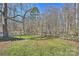 Picturesque backyard bordered by a rustic fence and a large expanse of trees at 9505 Kent Village Dr, Charlotte, NC 28269