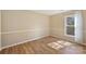 Simple and well-lit room with wood-look floors and natural light from the window at 9505 Kent Village Dr, Charlotte, NC 28269