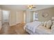 Spacious bedroom with bright windows, warm colors, and wood-look floors at 9505 Kent Village Dr, Charlotte, NC 28269