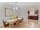 Dining room with hardwood floors, a modern chandelier, and an open view to the kitchen at 9505 Kent Village Dr, Charlotte, NC 28269