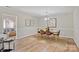 Well-lit dining room with a wooden table, leather chairs, rug, and artwork at 9505 Kent Village Dr, Charlotte, NC 28269