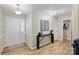Inviting entryway showcasing wood floors, a stylish console table, and elegant lighting fixtures at 9505 Kent Village Dr, Charlotte, NC 28269