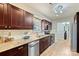 Modern kitchen featuring wooden cabinets, granite countertops, and stainless steel appliances at 9505 Kent Village Dr, Charlotte, NC 28269