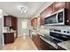 Modern kitchen with granite countertops, stainless steel appliances, and wooden cabinets at 9505 Kent Village Dr, Charlotte, NC 28269