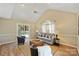 Bright living room with vaulted ceilings, ceiling fan, neutral paint, and access to deck at 9505 Kent Village Dr, Charlotte, NC 28269