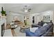 Open-concept living room featuring a modern ceiling fan, recessed lighting, and seamless flow to the dining area at 9505 Kent Village Dr, Charlotte, NC 28269