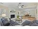 Bright living room featuring fireplace and a modern ceiling fan at 9505 Kent Village Dr, Charlotte, NC 28269