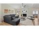 Comfortable living area with a cozy fireplace, plush sofa, and bright natural light from large windows at 9505 Kent Village Dr, Charlotte, NC 28269