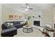 Comfortable living area with a cozy fireplace, plush sofa, and bright natural light from large windows at 9505 Kent Village Dr, Charlotte, NC 28269