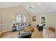 Bright living room with vaulted ceilings, ceiling fan, neutral paint, and lots of natural light at 9505 Kent Village Dr, Charlotte, NC 28269