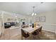 Open floor plan with the living room and dining room boasting hardwood floors at 9505 Kent Village Dr, Charlotte, NC 28269