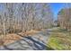 Tree-lined street creates a serene and picturesque neighborhood, enhancing the home's curb appeal at 9505 Kent Village Dr, Charlotte, NC 28269