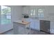 Well-lit kitchen with stainless steel dishwasher, white cabinetry, and a functional kitchen island at 108 Jackson St, Fort Mill, SC 29715