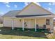This cozy back porch features charming seating, offering a relaxing outdoor space at 111 Lynnette Dr, Mt Ulla, NC 28125