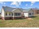 Backyard with brick and vinyl siding, complemented by a well-maintained lawn at 111 Lynnette Dr, Mt Ulla, NC 28125