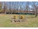 The spacious backyard features mature trees and a lovely garden area, creating a serene outdoor oasis at 111 Lynnette Dr, Mt Ulla, NC 28125