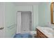 A full bathroom featuring a walk-in shower with white shower curtain, a toilet, and a marble countertop sink at 111 Lynnette Dr, Mt Ulla, NC 28125