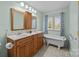 This relaxing bathroom is complete with a double vanity and a soaking tub under a window at 111 Lynnette Dr, Mt Ulla, NC 28125