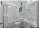 Well-lit bathroom featuring a shower/tub combo, a single sink, a mirror, and a toilet at 111 Lynnette Dr, Mt Ulla, NC 28125