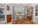 Bright breakfast nook with large windows, table with chairs, and bookshelf at 111 Lynnette Dr, Mt Ulla, NC 28125
