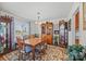 Traditional dining room featuring a wooden table and chairs, a china cabinet, and a window at 111 Lynnette Dr, Mt Ulla, NC 28125