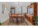 Traditional dining room with wooden table and chairs, china cabinet, and bright window at 111 Lynnette Dr, Mt Ulla, NC 28125