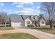 Inviting curb appeal with a well-manicured lawn, a spacious driveway, and an attached garage, ready to welcome you home at 111 Lynnette Dr, Mt Ulla, NC 28125