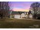 Charming single-Gathering home with a two-car garage, well-maintained lawn and cozy curb appeal at sunset at 111 Lynnette Dr, Mt Ulla, NC 28125