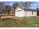 Detached garage with a roll-up door, providing ample space for parking and storage, set in a well-kept yard at 111 Lynnette Dr, Mt Ulla, NC 28125