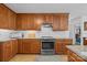 Well-lit kitchen features wood cabinets, granite counters, and stainless steel oven at 111 Lynnette Dr, Mt Ulla, NC 28125