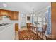 Bright kitchen with a breakfast nook and wooden cabinetry with large windows and natural light at 111 Lynnette Dr, Mt Ulla, NC 28125