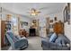 A cozy living room featuring comfortable seating, natural light, and a ceiling fan at 111 Lynnette Dr, Mt Ulla, NC 28125