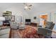 Open living room with vaulted ceilings showcasing a large rug, neutral furniture, and entry to kitchen at 111 Lynnette Dr, Mt Ulla, NC 28125