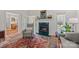 Comfortable living room featuring a fireplace, large window, and access to other rooms at 111 Lynnette Dr, Mt Ulla, NC 28125