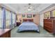 Relaxing main bedroom with tray ceiling features a ceiling fan and three large windows at 111 Lynnette Dr, Mt Ulla, NC 28125