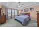 Relaxing main bedroom features a tray ceiling, ceiling fan, and three large windows at 111 Lynnette Dr, Mt Ulla, NC 28125