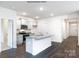 Well-lit kitchen showcasing white cabinets, stainless steel appliances, and a functional island at 1377 6Th Ne St, Hickory, NC 28601