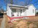 Charming single Gathering house showing front porch with chairs, white siding and foundation painted a reddish hue at 1440 10Th Sw Ave, Hickory, NC 28602