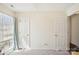 Light, bright bedroom with two doors and a large window, ready for personalization at 14429 Planters Knob Ln, Charlotte, NC 28273