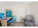 Bedroom featuring desk with blue accents, cozy reading area, and carpeted floor at 14429 Planters Knob Ln, Charlotte, NC 28273