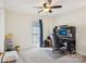 Spacious bedroom with ceiling fan, desk with computer, and neutral-colored carpet at 14429 Planters Knob Ln, Charlotte, NC 28273