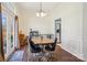Bright dining room with hardwood floors, large windows, and an open layout to the backyard at 14429 Planters Knob Ln, Charlotte, NC 28273