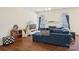 Comfortable living room with hardwood floors, large windows, and a fireplace at 14429 Planters Knob Ln, Charlotte, NC 28273